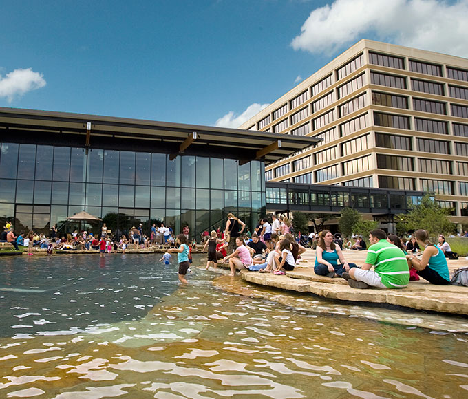 A sky-bridge links the tower to a new interim worship space and a glass box lobby that opens to the baptismal pond, lawn and firepit. 